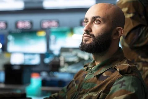 Close up of army operator looking at command center displays Stock Photos