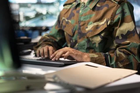 Close up of army operator typing enemy target coordinates on PC keyboard Stock Photos
