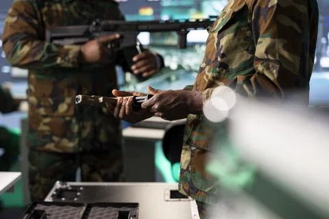 Close up of army soldier loading handgun, doing weapon inspection Stock Photos