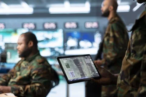 Close up of army soldier using tablet displaying tactical map Foto stock