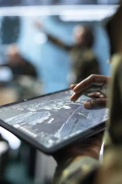 Close up of army specialist using tablet app to do battlefield surveillance Stock Photos