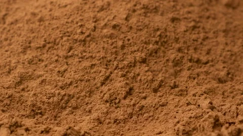 Close up of aromatic cacao powder pouring onto a pile in slow motion. Stock Footage 334872922