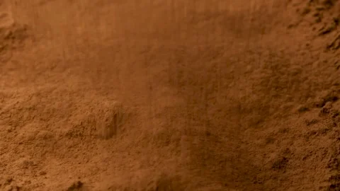 Close up of aromatic cacao powder pouring onto a pile in slow motion. Stock Footage 334872974