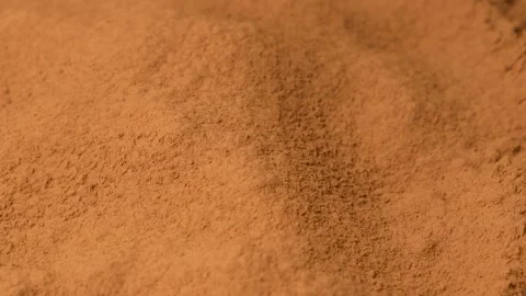 Close up of aromatic cacao powder pouring onto a pile in slow motion. Stock Footage 335836142