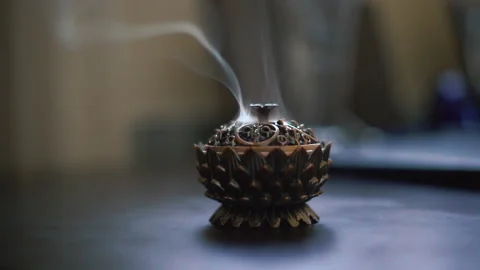 Close up aromatic incense burning on ancient coptic metal artwork. Stock Footage 201297286