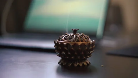 Close up aromatic incense burning on coptic metal on the background on laptop Stock Footage 201306970