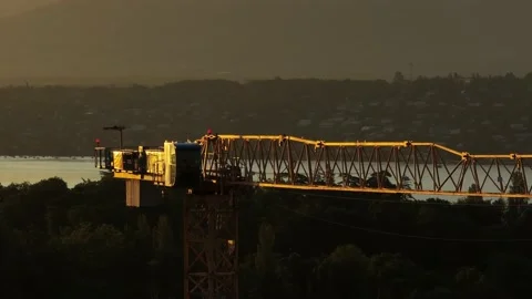 Close up around a crane with the sunset or sunrise in the background Stock Footage 233877194
