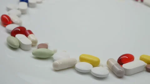 Close up, around rotating with red, white, colored pills Stock Footage 85743119
