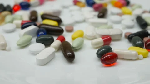 Close up, around rotating with red, white, colored pills Stock Footage 86213463