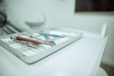Close up of array of dental tool in tray next to client Stock Photos