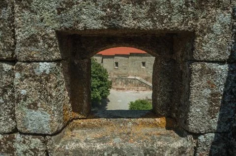 Close-up of arrow slit on stone wall of castle Stock Photos