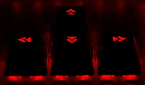 Close up arrows. Red light on the game keyboard. Stock Photos