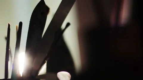 Close up art studio paint brushes light blows through the darkness artwork oil Stock Footage 98261581