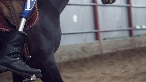 Close-up, artificial leg, limb in stirrups. male rider, disabled person, without Stock Footage 102157023