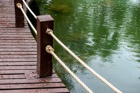 Close-up of artificial pond with rope railing on wooden walkway in Tomsk City Stock Photos