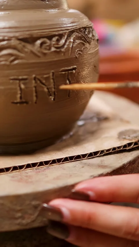 Close Up of Artisan Carving Intricate Patterns into Wet Clay Pottery Stock Footage 340179907