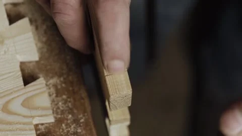 Close up. a artisan cuts out a dovetail on a wooden board with a hand saw. wo Stock Footage 166341052