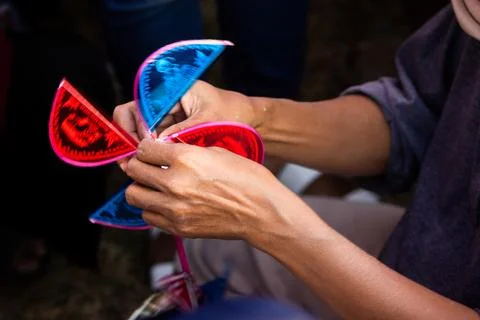 Close Up Of Artisan Hands Assembling Red And Blue Blades On Wooden Windmill.. Stock Photos