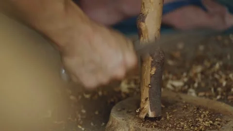 Close up of an artisan hands peeling bark with a knife Stock Footage 266864919