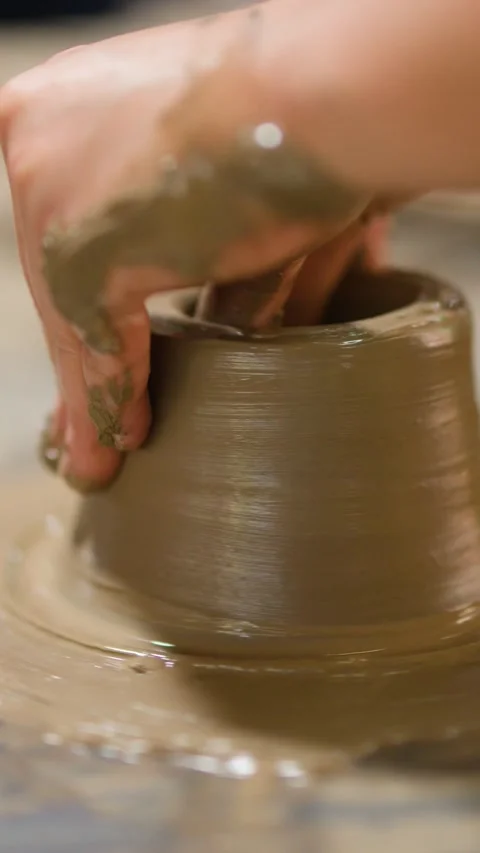 Close Up of Artisan Hands Shaping Wet Clay on Pottery Wheel Stock Footage 341302840