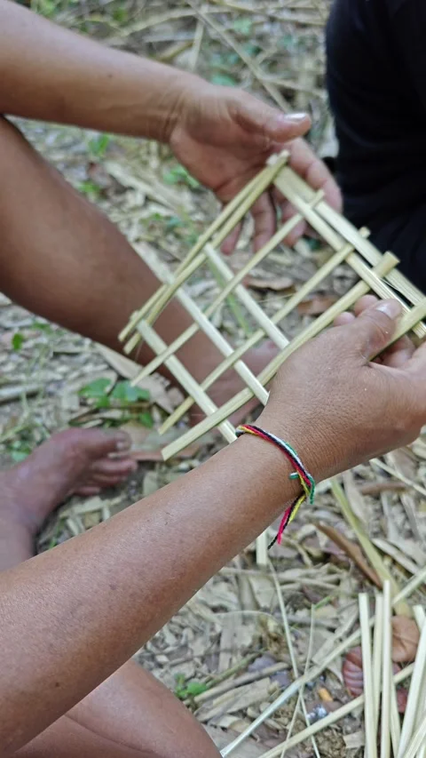 Close-up of Artisan Hands Weaving Traditional Bamboo Craft Outdoors Stock Footage 338269559