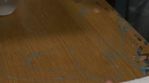 Close up an artist cleans her work surface with a tissue. in an artist's st.. Video stock 238937147