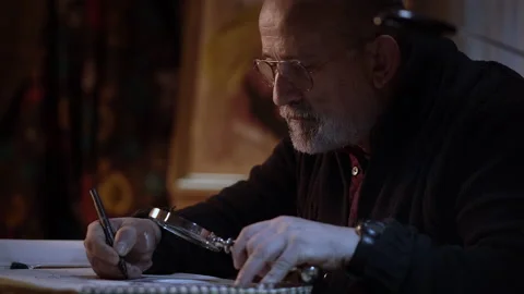 Close-up of an artist working in the studio. Older man painting a picture wit Stock Footage 152344823