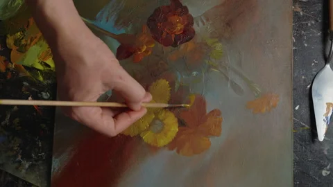 Close-up, artist's hand drawing a picture with flowers with oil paints in art Stock Footage 258794075