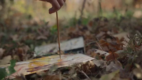 Close-up, the artist's hand paints a landscape of an autumn forest in watercolor Video stock 337118940