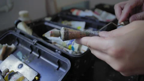 Close-up, Artist's Hands Hold Old Tube with Oil Paint Stock Footage 152745435
