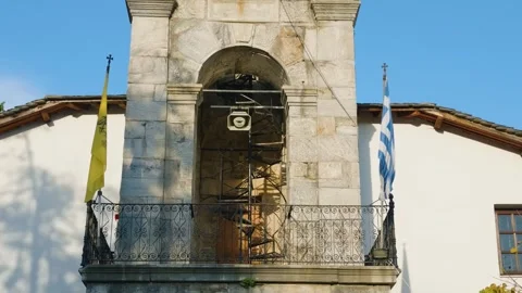 Close-up ascending view of a historic stone bell tower with iron railings and Stock Footage 346703638