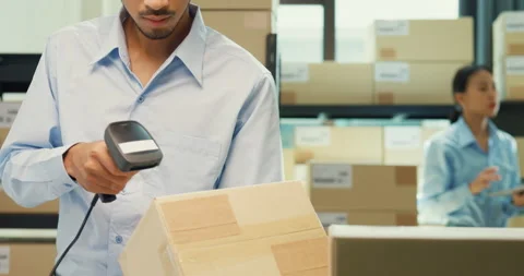 Close-up Asia man sit front desk computer use barcode machine scan record. Stock Footage 229649191
