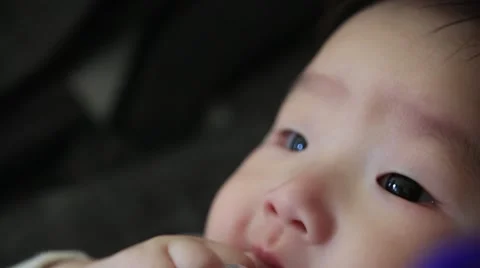 Close up of asian baby boy sucking his f... | Stock Video