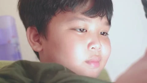 Close up asian boy face watching video on smartphone 스톡 동영상 157591496