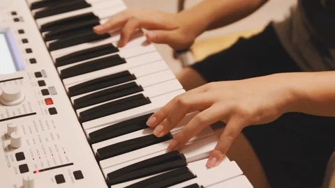 Close up of an asian boy hand practicing his piano lesson at home Stock Footage 107936826