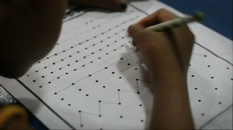 Close up of Asian boy lining up dots with a pencil Stock Footage 35538581