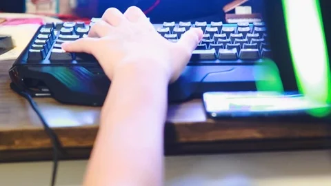 Close up of Asian boy playing game on his gaming computer with RGB gaming gear Stock Footage 107907942