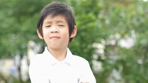 Close up of asian child pointing at camera outdoors slow motion Stock Footage 96579202