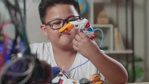 Close Up Of Asian Cute Boy Checking A Cyborg Hand At Home Stock Footage 212019035