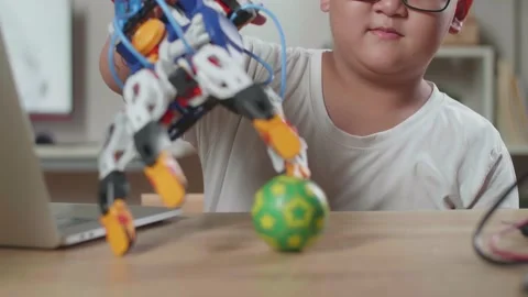 Close Up Of Asian Cute Boy With A Cyborg Hand Trying Holding A Small Ball While Stock Footage 212021204