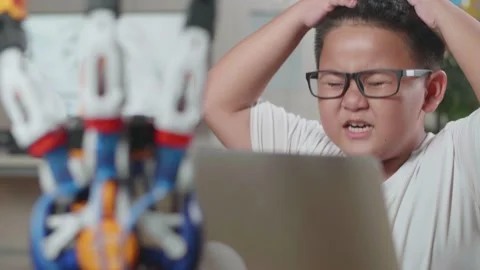 Close Up Of Asian Cute Boy Having A Headache While Working About A Cyborg Hand Stock Footage 212020467
