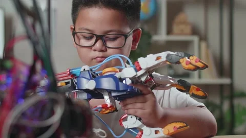 Close Up Of Asian Cute Boy Looking At Checking A Cyborg Hand At Home Stock Footage 212019582