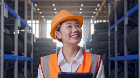 Close Up Of Asian Female Engineer Looking At The Tablet In Her Hand Tire Stock Footage 341788546