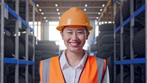 Close Up Of Asian Female Engineer Smiling To Camera at Tire Warehouse Stock Footage 341788395