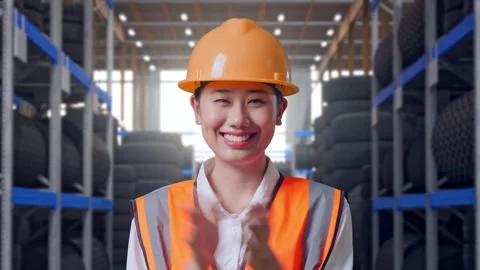 Close Up Of Asian Female Engineer Smiling And Clapping Her Hands Tire Warehouse Stock Footage 341789661