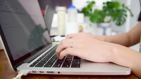 Close up of Asian female web developer writing code on computer laptop. Stock Footage 144385823