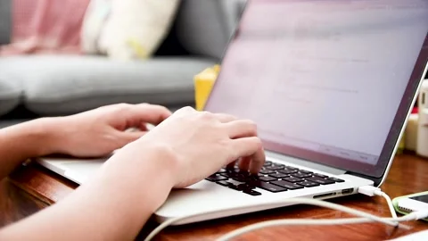 Close up of Asian female web developer writing code on computer laptop at home. Stock Footage 144385827