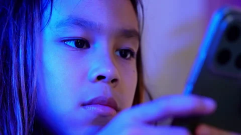 Close-up of an Asian girl using a smartphone at night Video stock 334768902