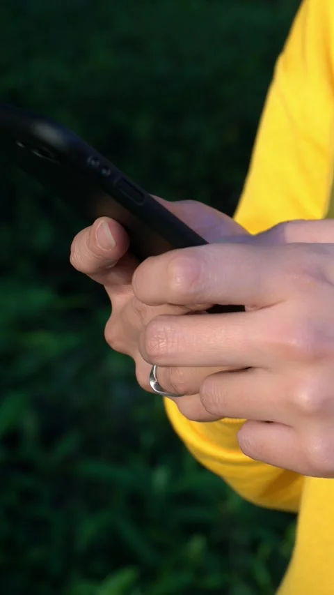Close up asian hands woman using a smartphone in park with green trees Stock Footage 317577509