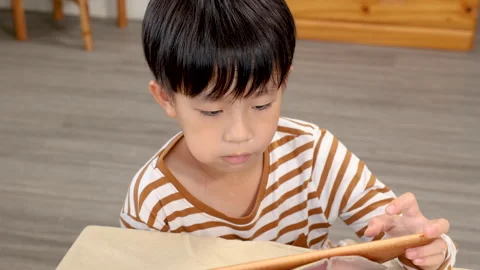 Close up of asian handsome kid sit eats the peeled fruit that mother feeds .. Stock-Footage 249590796